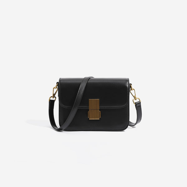 Mini structured black flap crossbody bag with gold-tone ribbed rectangular clasp and adjustable shoulder strap, front view