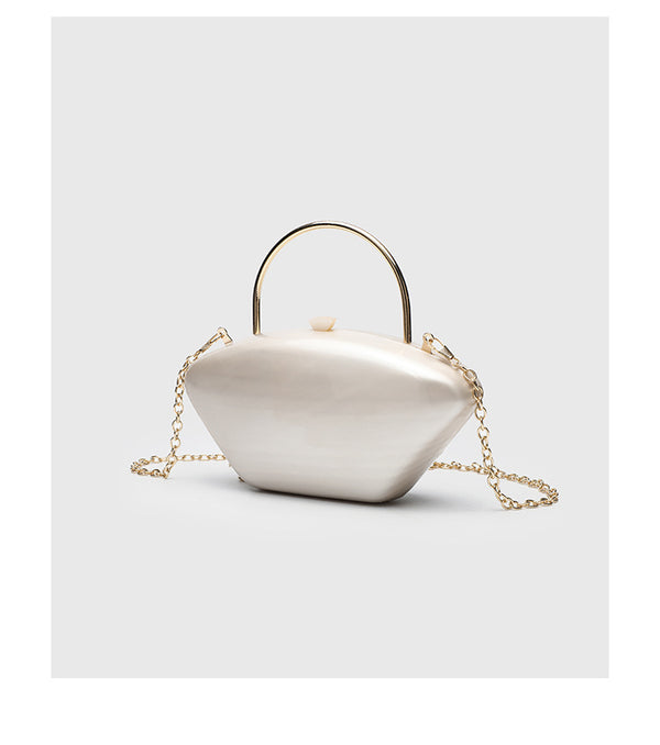 Shell-shaped pearlescent top-handle clutch bag with arched gold-tone metal handle and gold chain strap, detail view 11