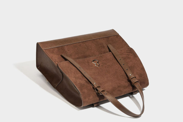 Structured suede-look convertible backpack handbag with flap closure and gold-tone emblem hardware in chocolate brown, detail