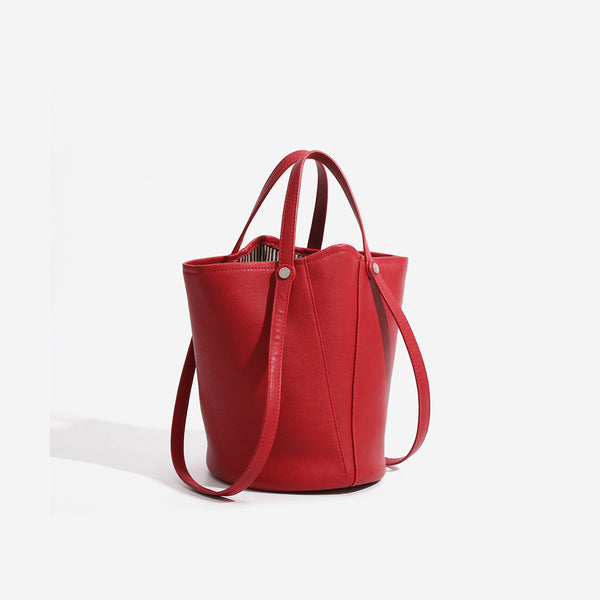 Large leather-look bucket tote bag with dual top handles and adjustable crossbody strap, detail view 3