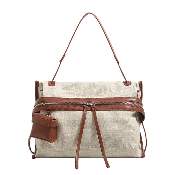 Off-white woven cotton-linen shoulder bag with brown leather-look trim, dual zip closure, long zipper pulls, front exterior