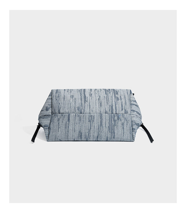 Large slouchy woven-texture shoulder tote bag with slim leather-look straps, side cinch ties, and silver-tone hardware