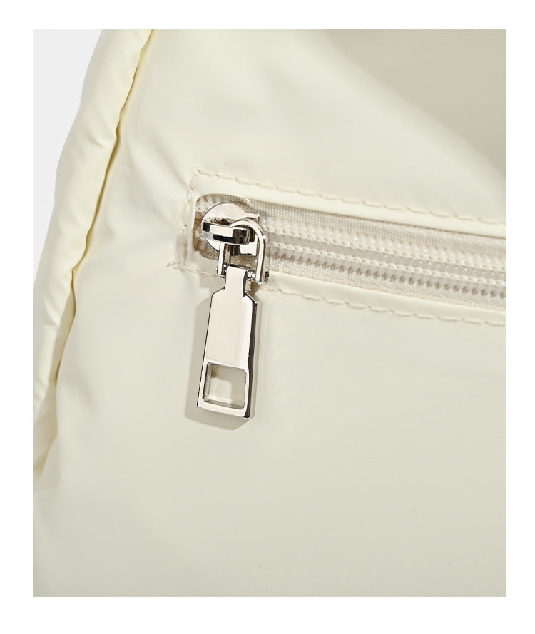 Puffy matte nylon mini backpack with drawcord gathered front pockets and silver-tone hardware, detail view 12