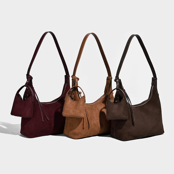 Dark brown suede-look hobo shoulder bag with top zip closure, adjustable strap, and small detachable mini pouch, detail view