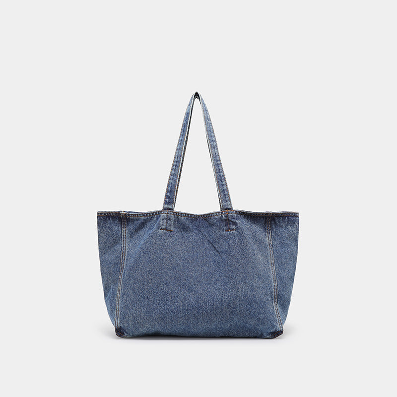 Große Tote Bag aus verwaschenem blauem Denim mit Grafikprint im handschriftlichen Stil, orangefarbenen Kontrastnähten und langem Stoffschulterriemen