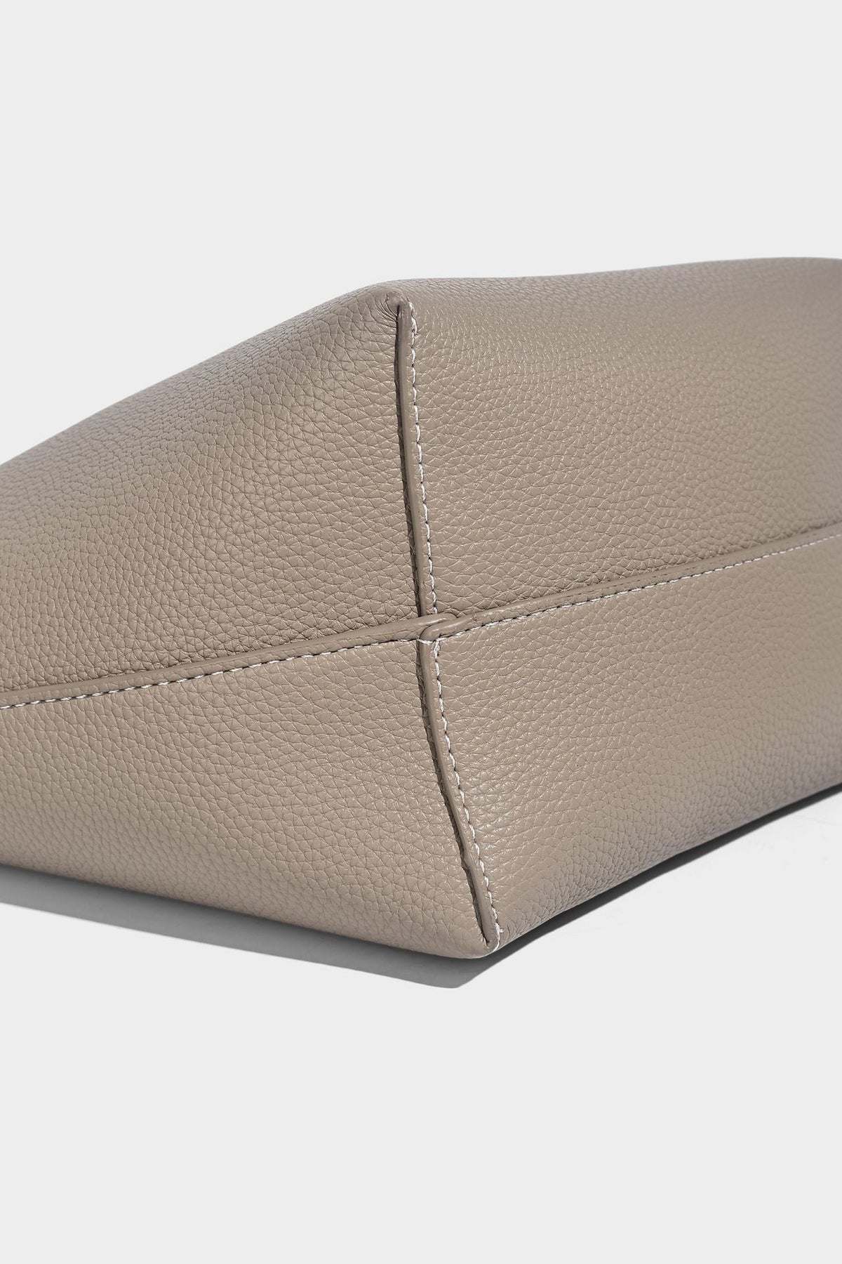 Structured pebbled leather-look tote bag in taupe with long shoulder strap, detachable zip pouch, and pink tulip flower