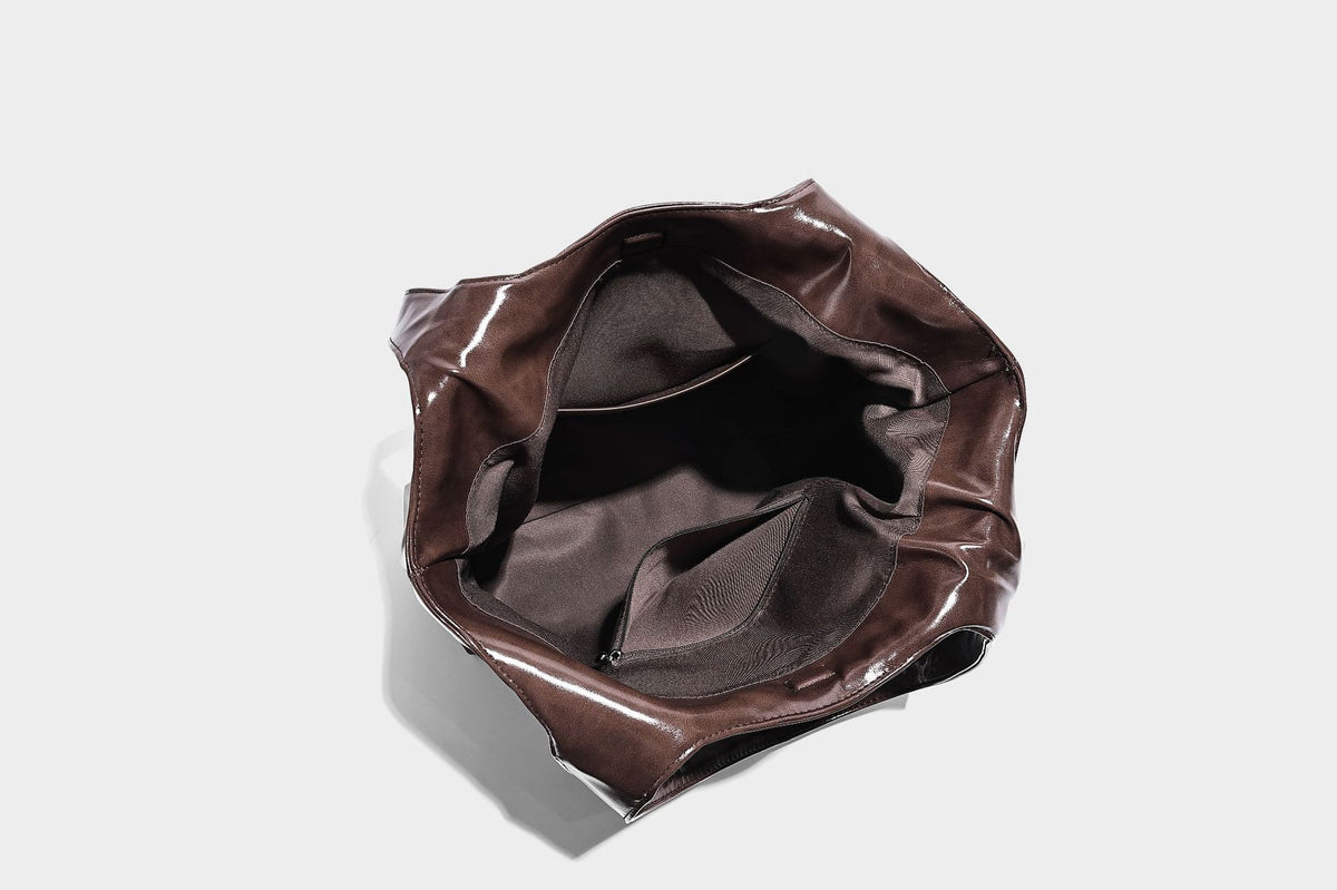 Glossy oil-wax leather-look open-top tote shoulder bag with embossed circular logo and long double straps, detail view 32