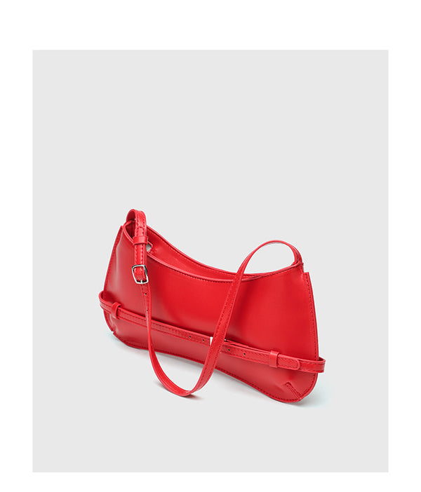 Curved baguette shoulder bag with front buckle strap and adjustable thin strap in glossy leather-look finish, detail view 10