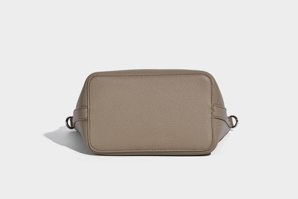 Compact pebbled bucket tote bag with elephant charm, twin top handles, and detachable crossbody strap, detail view 32
