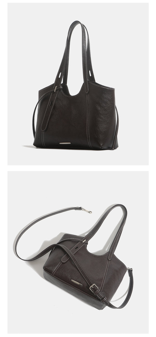 Structured leather-look tote shoulder bag with double crossed straps, contrast topstitching, and metal bar hardware, detail