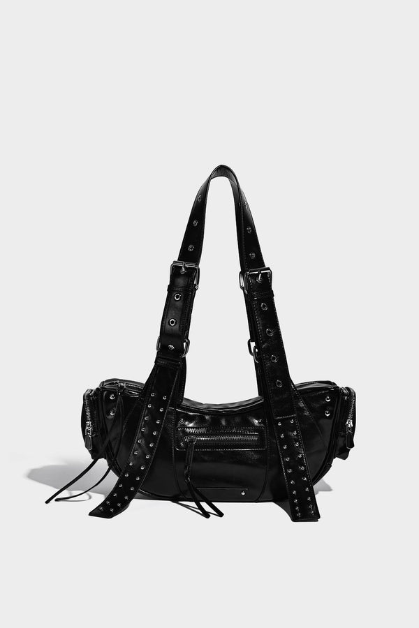 Glossy black crescent shoulder bag with silver-tone rivets, multiple zip pockets, and long adjustable studded straps, detail