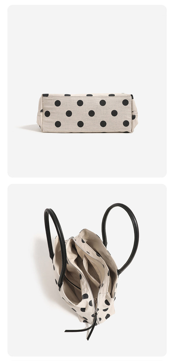 Cream canvas tote bag with black polka dots, rounded leather-look handles, and zip-top closure, detail view 11