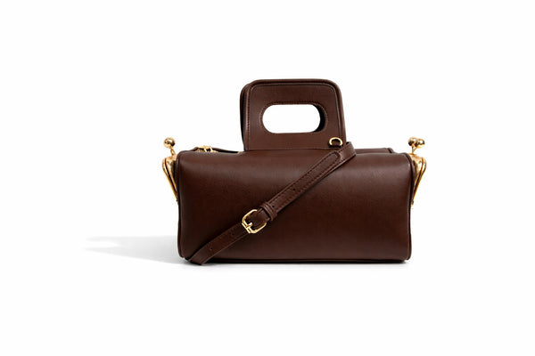 Kompakte dunkelbraune Henkeltasche in Lederoptik mit goldfarbenem Rahmenbeschlag und abnehmbarem, verstellbarem Crossbody-Riemen