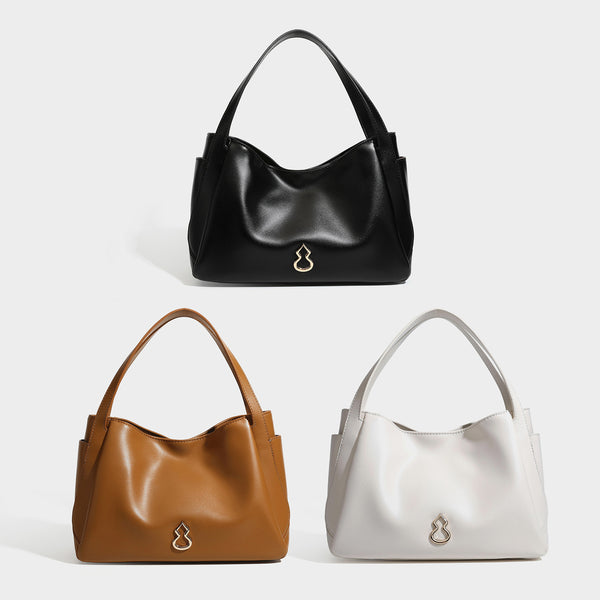 Structured glossy leather-look tote shoulder bag with dual top handles, detachable crossbody strap, side pockets, and, detail