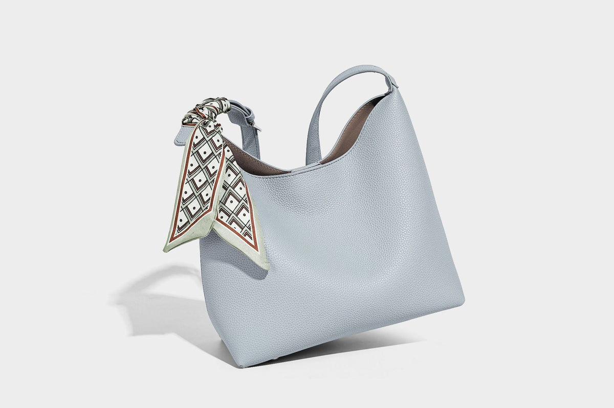 Soft slouchy hobo shoulder bag in pebbled matte finish with slim strap, silver-tone ring hardware, and knotted printed scarf