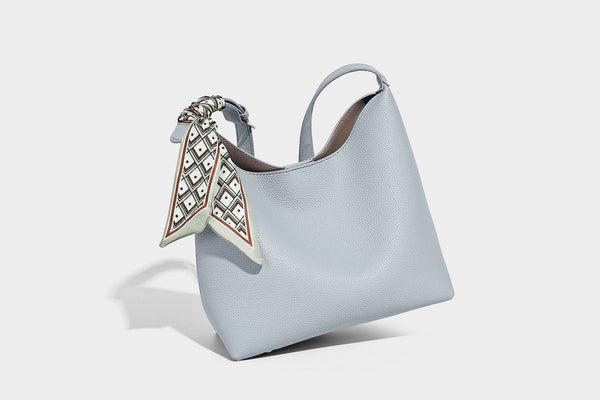 Soft slouchy hobo shoulder bag in pebbled matte finish with slim strap, silver-tone ring hardware, and knotted printed scarf