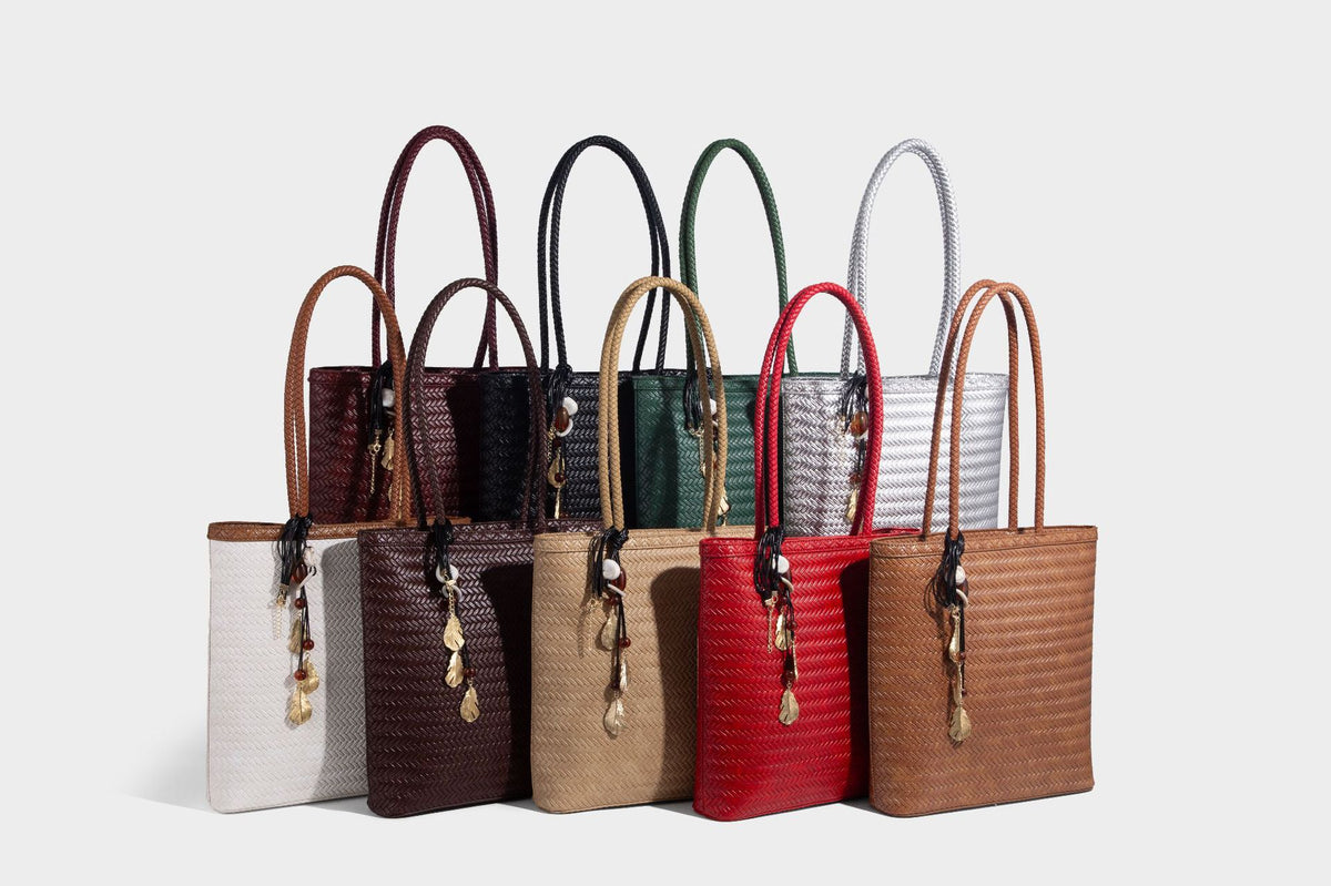 Structured woven herringbone tote bag with braided double shoulder handles in tan brown, shown with matching drawstring