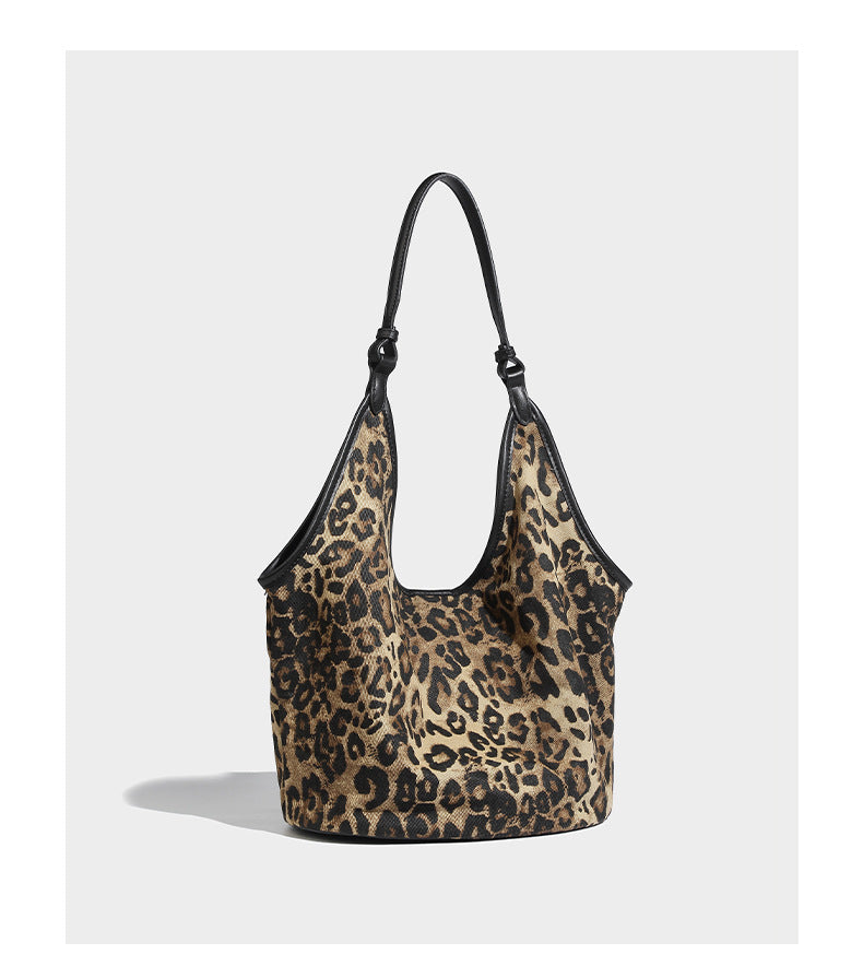 Slouchy brown leopard jacquard hobo tote bag with black leather-look trim and single shoulder strap, shown with black, detail