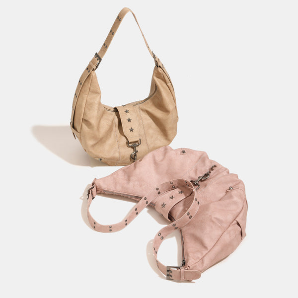 Crescent hobo shoulder bag in matte leather-look finish with star stud front panel, antique-silver hook hardware, and, front