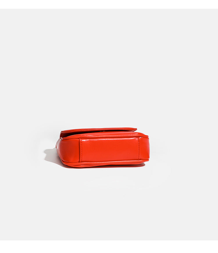 Compact rounded rectangular flap crossbody bag with glossy leather-look finish and long shoulder strap, detail view 14