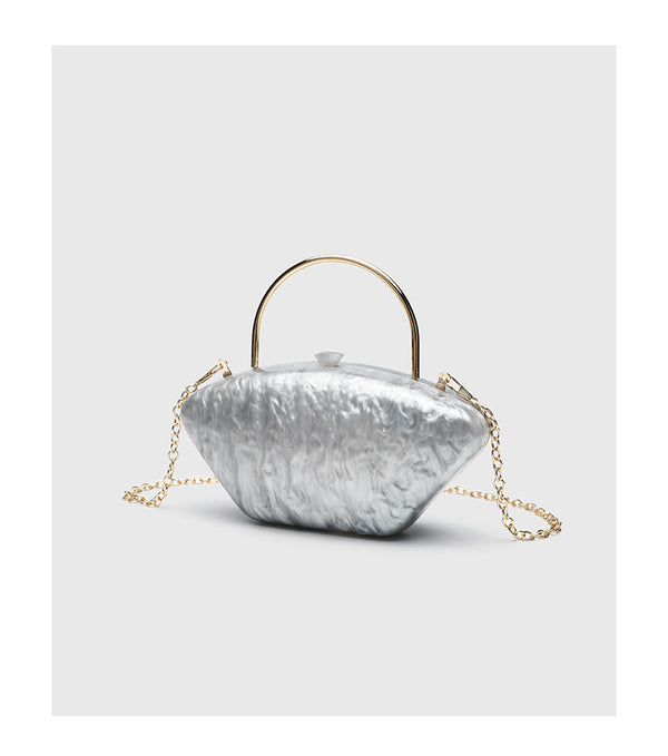 Shell-shaped pearlescent top-handle clutch bag with arched gold-tone metal handle and gold chain strap, detail view 15