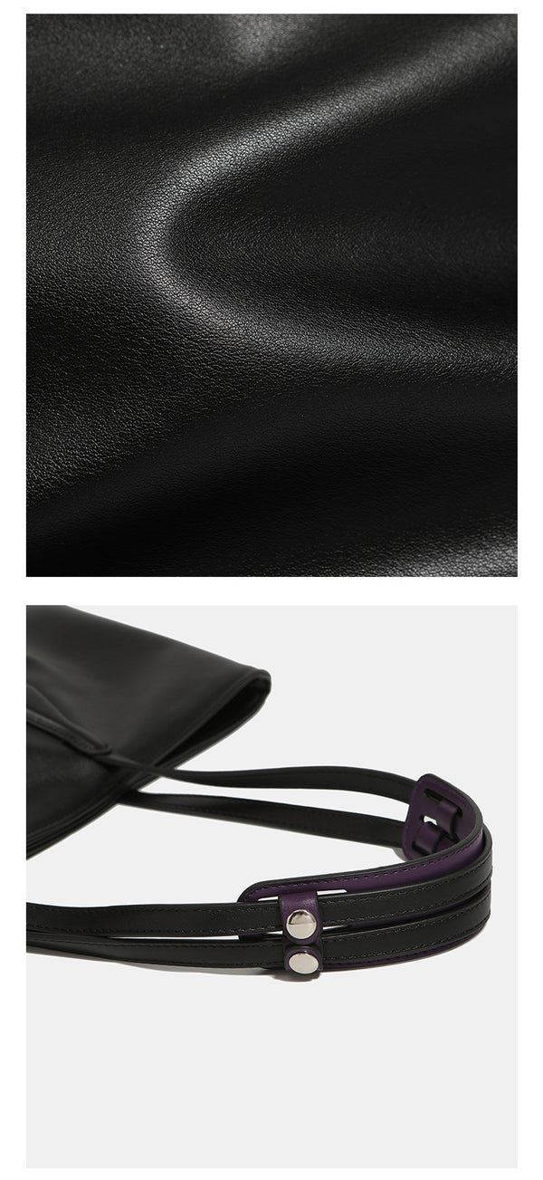 Large black leather-look trapezoid tote bag with double shoulder straps and purple accent hardware, detail view 10