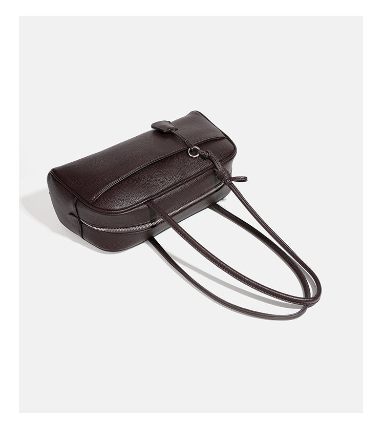 Structured rounded rectangular shoulder bag with pebbled leather-look finish, dual long handles, top zipper, front zip