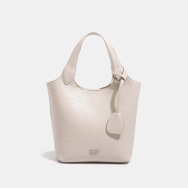 Soft glossy leather-look bucket tote bag with twin handles and detachable crossbody strap, detail view 7