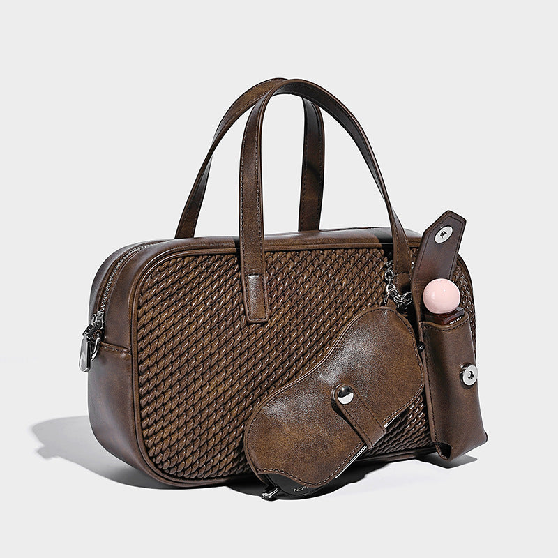 Structured woven-texture front top-handle handbag with zip closure, dual handles, detachable shoulder strap, and matching