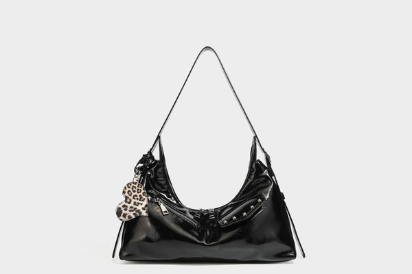Glossy dark brown hobo shoulder bag with slim strap, front zip pocket, stud detail, and detachable leopard-print heart charm