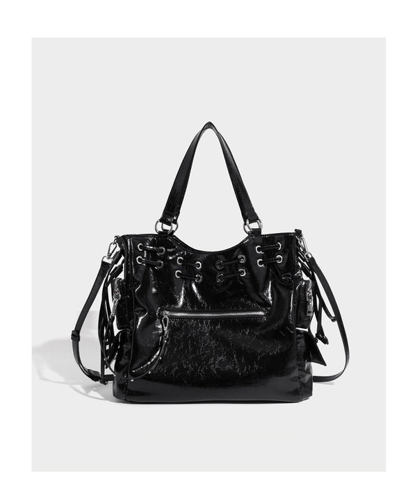 Glossy crinkled leather-look tote bag with silver grommet lace-up front detail, dual top handles, and detachable shoulder
