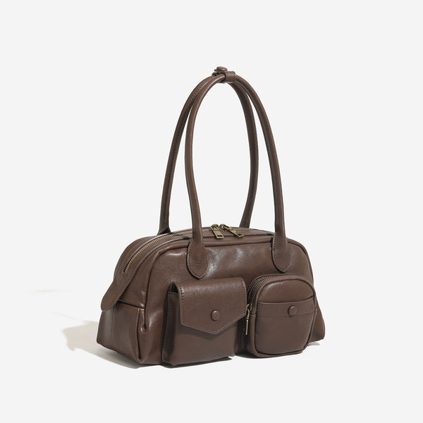Structured retro bowling-style top-handle handbag with dual zip closure, front snap-flap pocket, and front zip pocket, detail