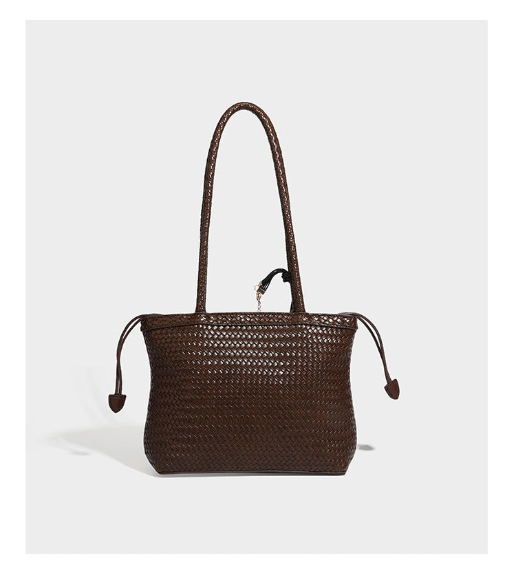 Structured woven leather-look tote bag in dark brown with long shoulder straps, side drawstring ties, and gold filigree