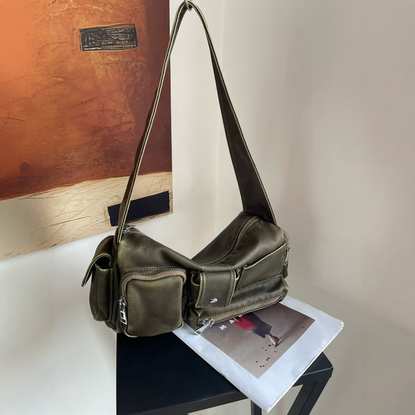 Slouchy multi-pocket leather-look shoulder bag with silver-tone hardware and adjustable strap, front view