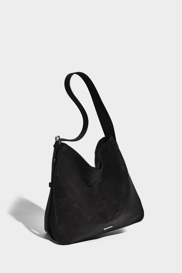 Large slouchy hobo shoulder bag in matte leather-look finish with adjustable strap and gold-tone bar hardware, detail view 20