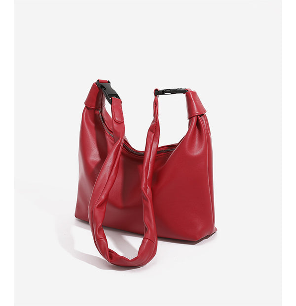 Slouchy leather-look hobo bag with knotted loop handle and top zipper closure, detail view 9