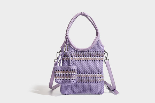 Color-block woven tote bag with rounded leather-look handles, detachable crossbody strap, and matching mini clip-on pouch in