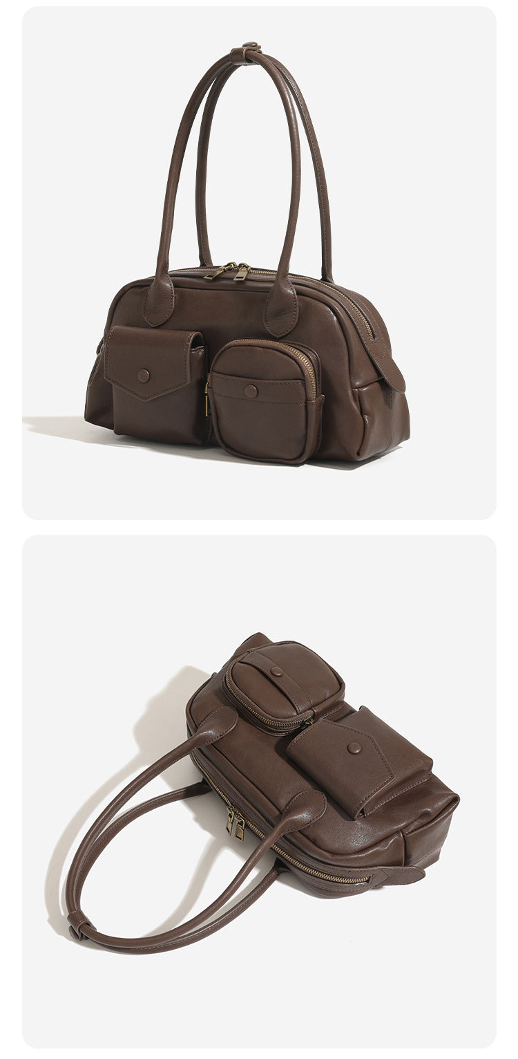 Structured retro bowling-style top-handle handbag with dual zip closure, front snap-flap pocket, and front zip pocket, detail