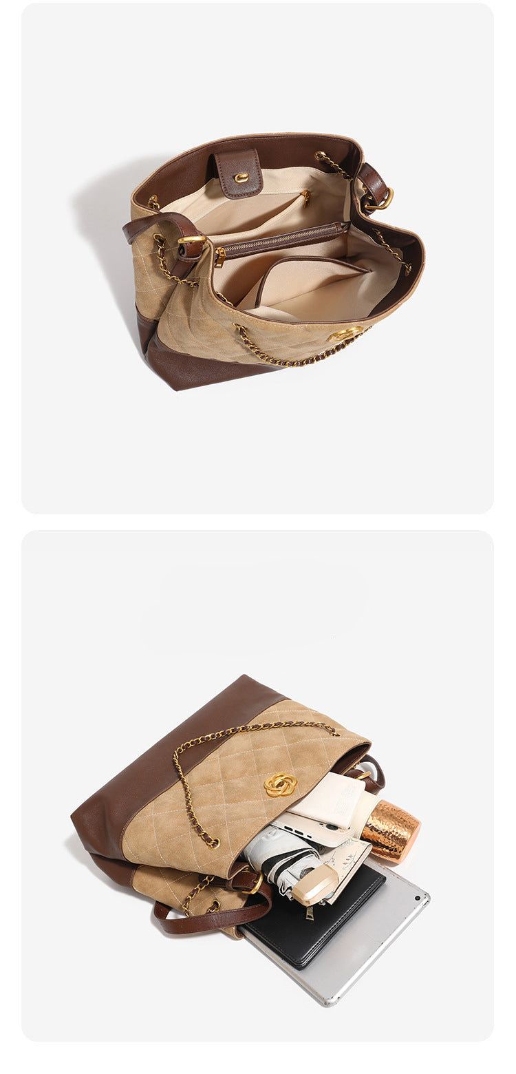 Two-tone tan quilted and dark brown leather-look tote bag with gold chain strap and floral knot emblem, detail view 10