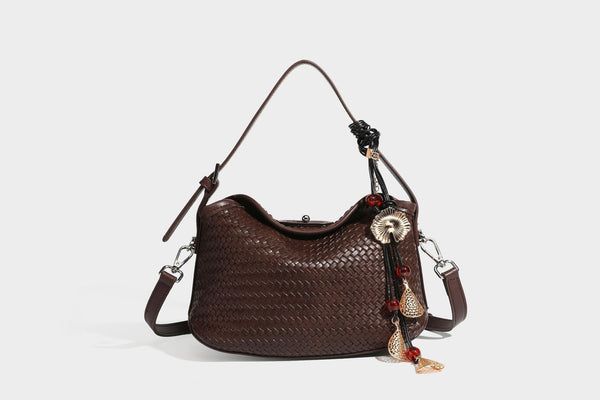 Small woven-look leather-look flap shoulder hobo bag in burgundy with silver-tone hardware and decorative tassel charm