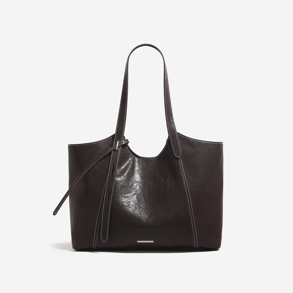 Structured leather-look tote bag with tall dual shoulder straps, front tie detail, contrast white topstitching, and, detail