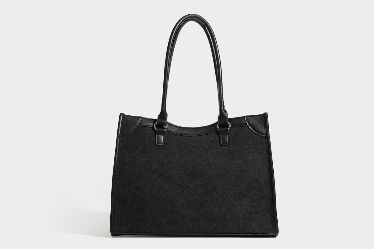 Large structured tote bag with matte suede-like body, smooth leather-look trim, front zip pocket, stud hardware, and