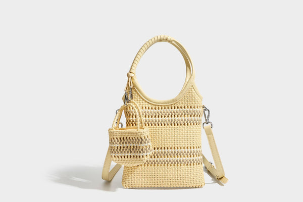 Color-block woven tote bag with rounded leather-look handles, detachable crossbody strap, and matching mini clip-on pouch in