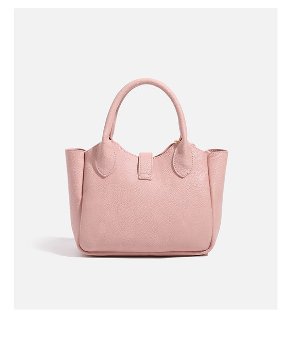 Small structured pebbled leather-look mini tote bag with gold-tone hardware, front toggle closure, knotted bear tassel charm