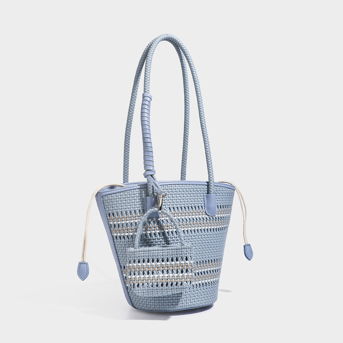 Light blue open-weave woven bucket tote bag with long braided shoulder straps, drawstring side ties, and attached mini pouch