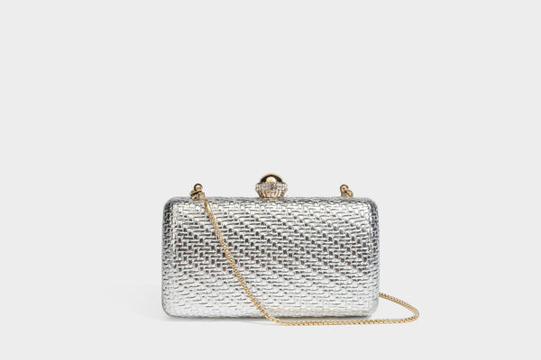 Small structured metallic woven-texture box clutch bag with jeweled kiss-lock dome clasp and slim gold chain strap, detail