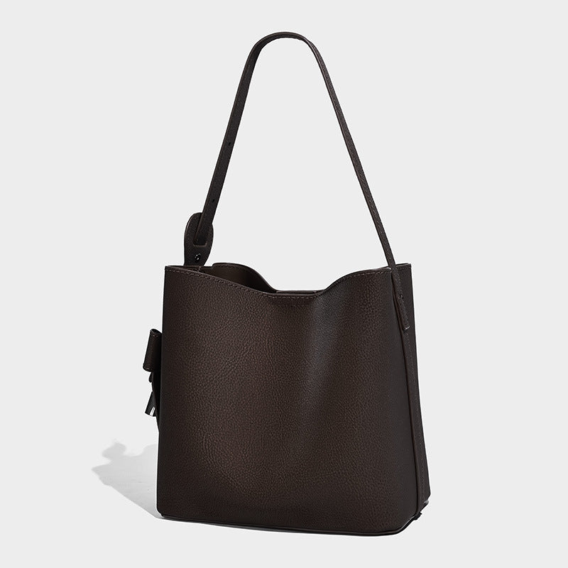 Pebbled leather-look bucket shoulder bag with zip inner pouch and adjustable crossbody strap, front view