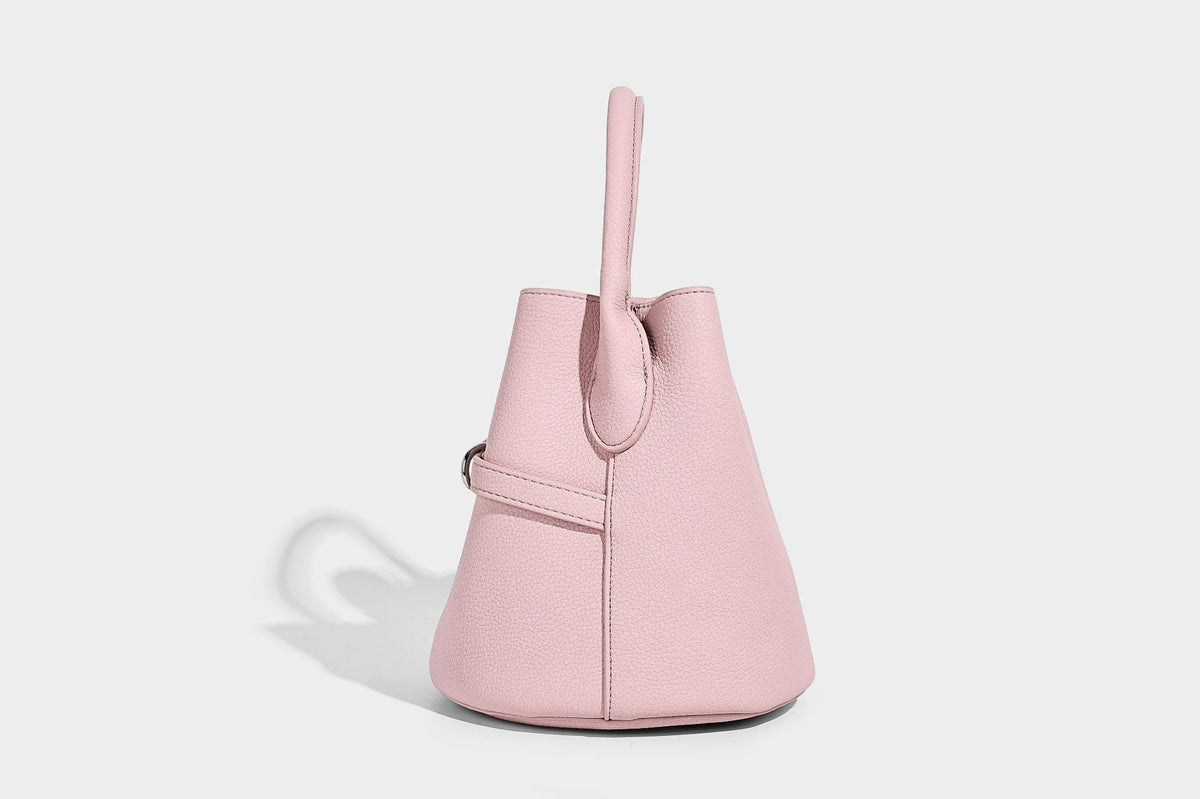 Mini pebbled leather-look bucket bag with front buckle strap, silver-tone hardware, top handle, and detachable shoulder