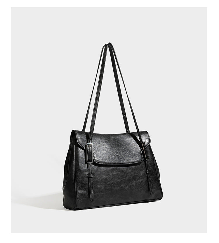 Large structured shoulder tote bag in wine red textured leather-look finish with front flap closure and silver-tone buckle