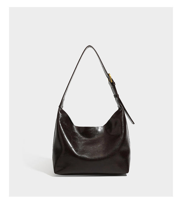 Dunkelbraune, lässig fallende Hobo-Schultertasche mit velourslederähnlich strukturierter Oberfläche, glatter lederähnlicher Paspelierung und Details in Antikgoldoptik, Detailansicht